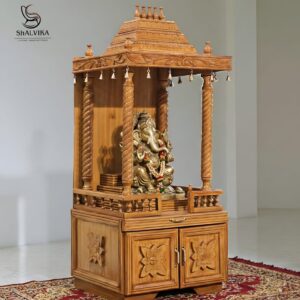 Design of wooden mandir in teak wood with South Indian gopuram and brass bells by Shalvika Living